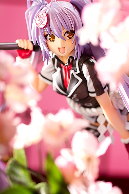 Kanetsugu smiling behind some flowers